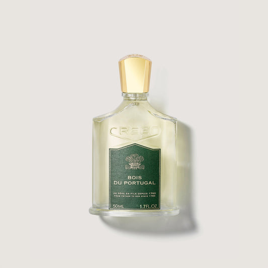 Frasco de perfume Creed Bois du Portugal de 50 ml con tapón dorado en un fondo claro.